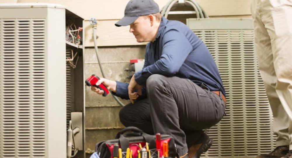 Man cleaning air conditioner coils for maintenance